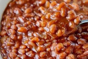 Baked beans in bowl, with spoon in the bowl