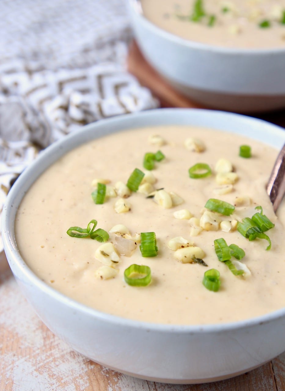 Creamy sweet corn chowder in bowl with copper spoon