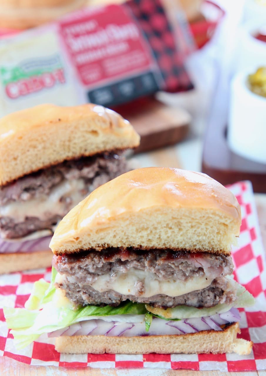 Juicy lucy burger cut in half with melted cheese in the middle