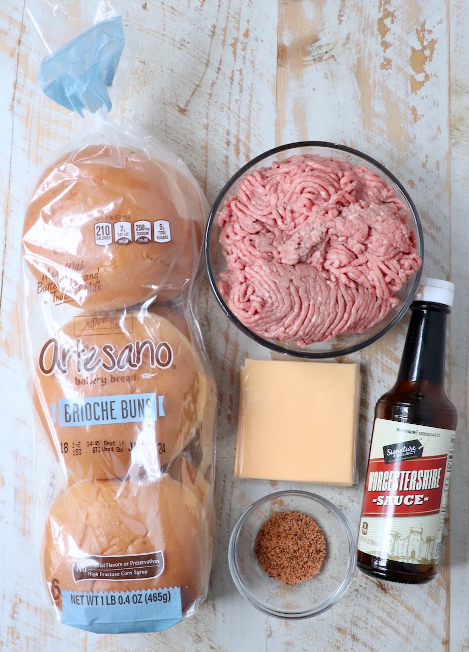 ingredients for juicy lucy burgers on white wood board