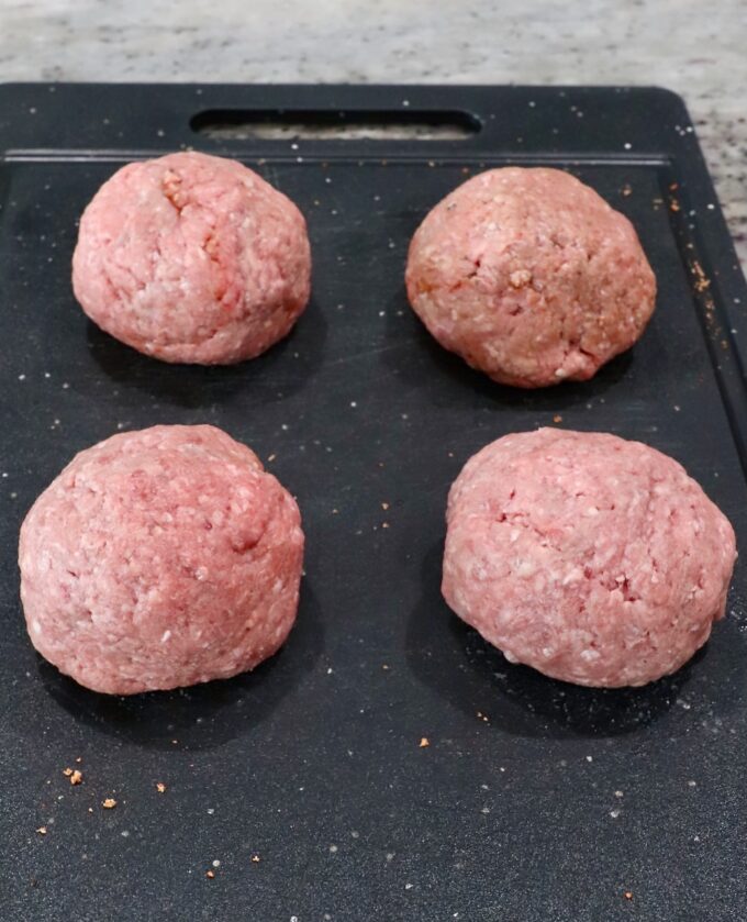 balls of ground beef on a cutting board