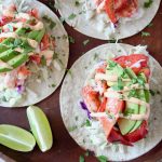 Overhead image of lobster tacos topped with remoulade sauce
