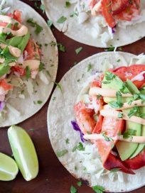 Overhead image of lobster tacos topped with remoulade sauce