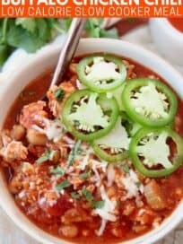 Overhead image of buffalo chicken chili in bowl topped with sliced jalapenos
