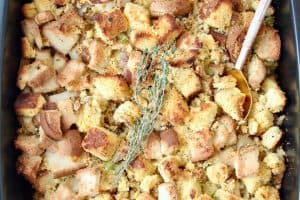 Gluten free stuffing in roasting pan with serving spoon