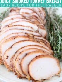Sliced turkey breast on plate with fresh herbs