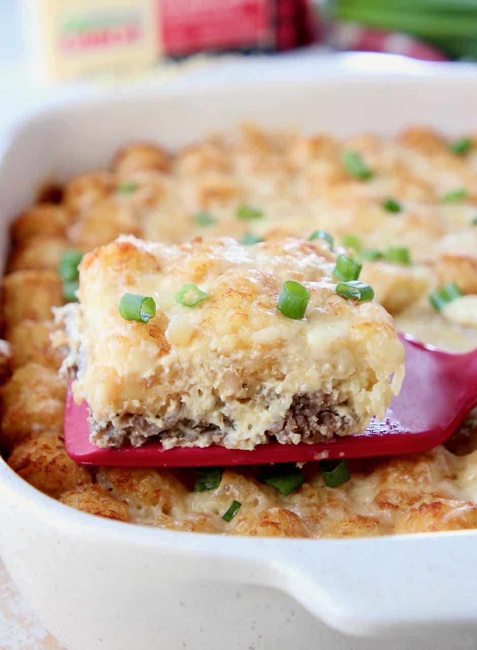 Slice of breakfast casserole on spatula coming out of the casserole dish