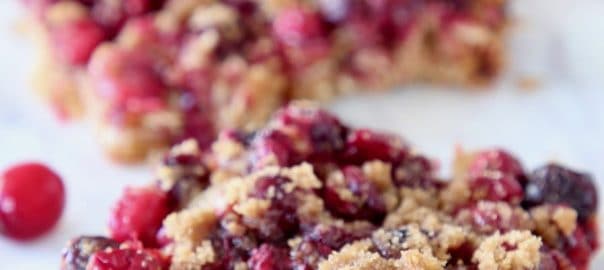 Oatmeal Cranberry Bars cut into squares on marble serving tray