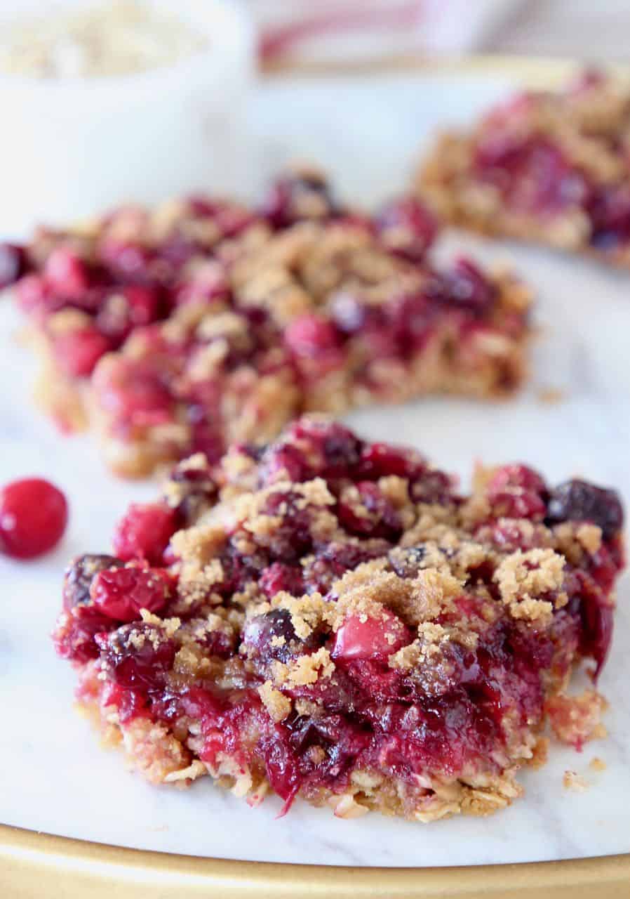 Oatmeal Cranberry Bars cut into squares on marble serving tray
