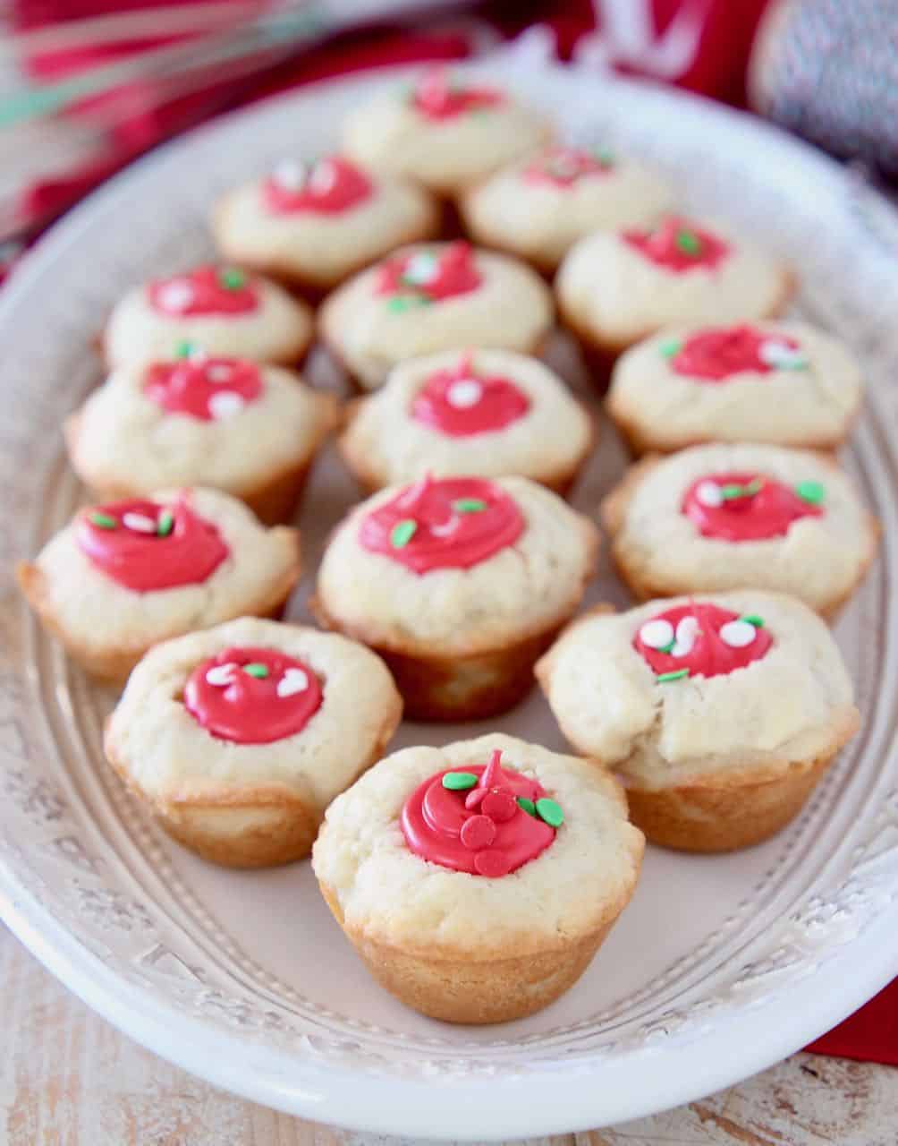 Sugar cookie cups filled with red frosting on white plate