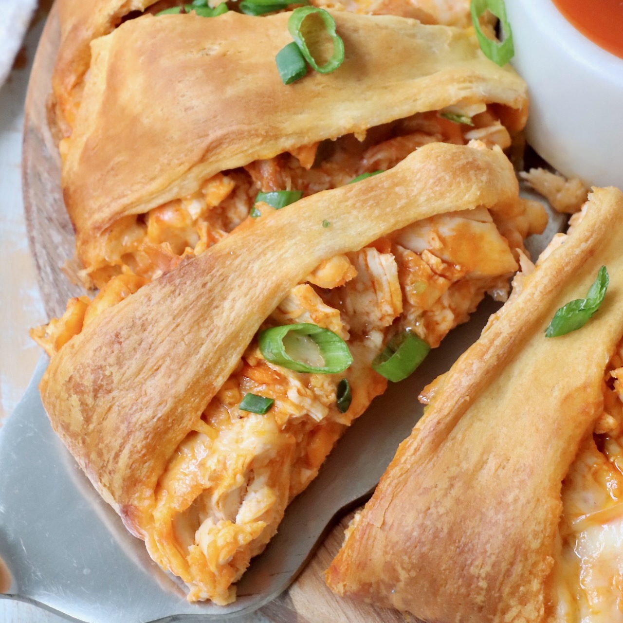 slice of buffalo chicken ring on a spatula