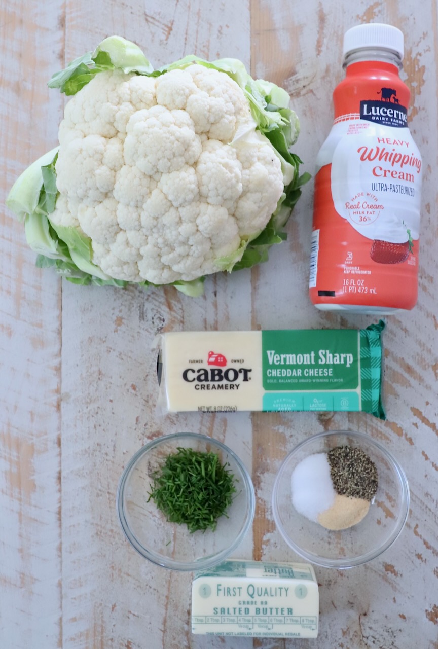 ingredients for mashed cauliflower on a white wood board