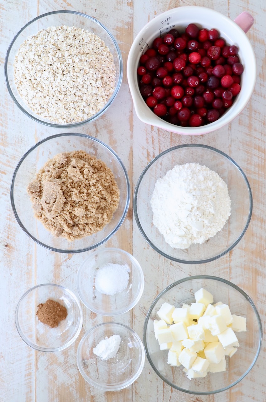 ingredients for oatmeal cranberry bars on white wood board