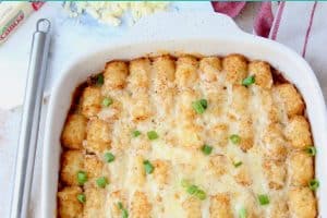Tater tot casserole in baking dish with spatula