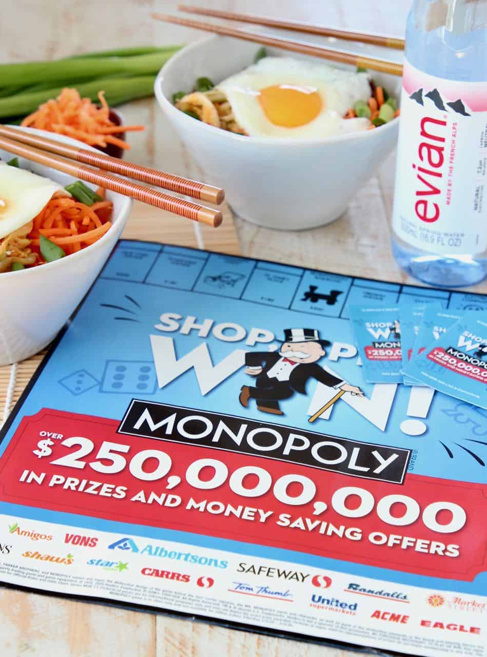 Monopoly game board with evian bottle water and rice bowls