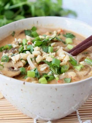 Noodle soup in bowl with brown chopsticks