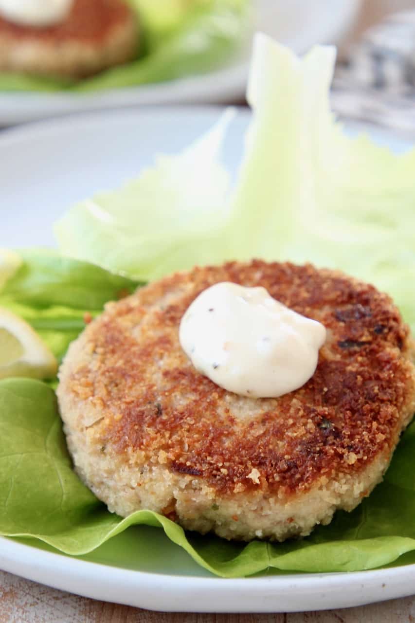 Crispy tuna cake on leaf of butter lettuce, topped with garlic aioli