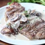 Strip steak on plate, topped with creamy mushroom sauce