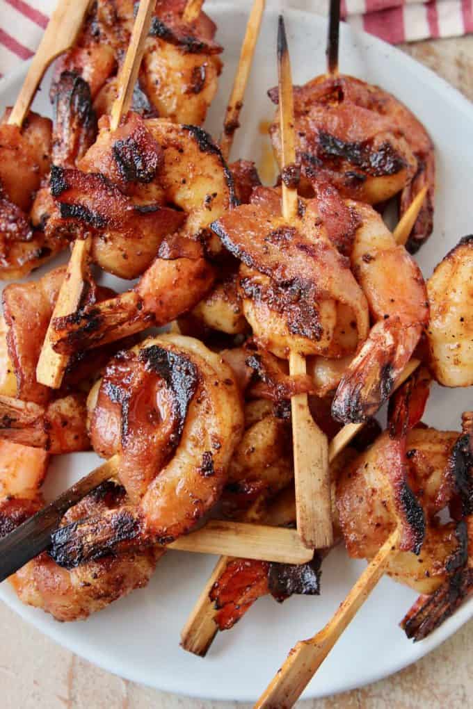 skewered bacon wrapped shrimp on plate