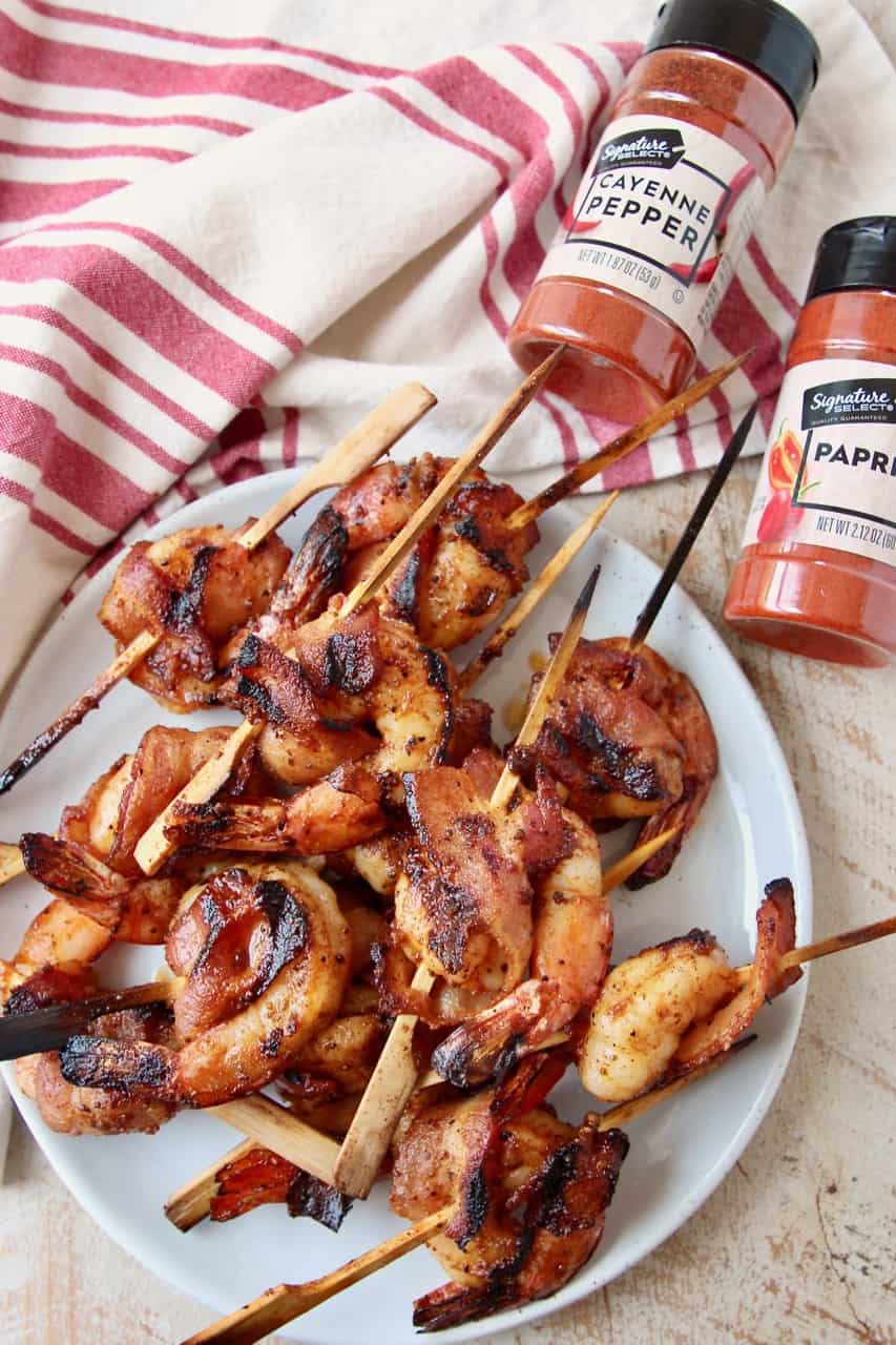 Skewered bacon wrapped shrimp on plate