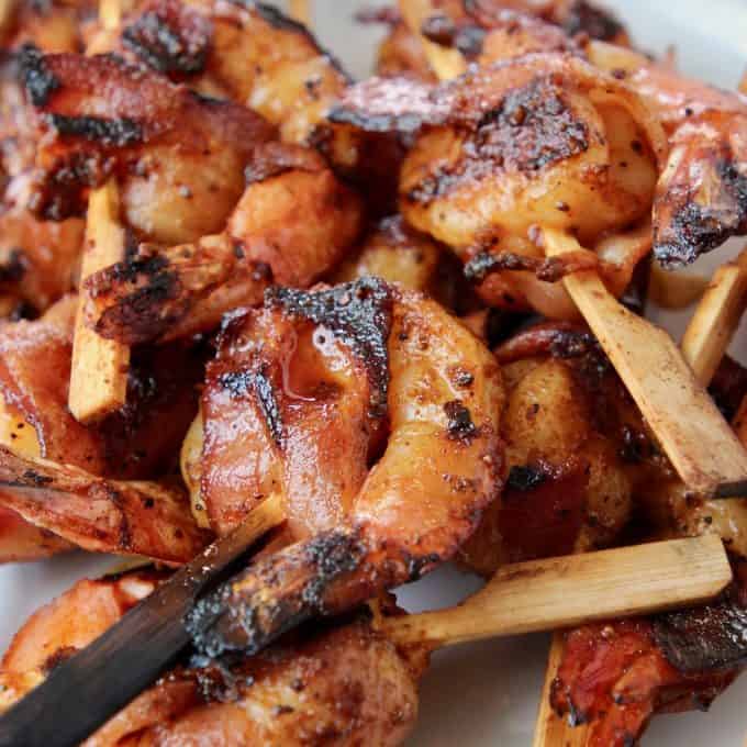 Skewered shrimp wrapped in bacon slices