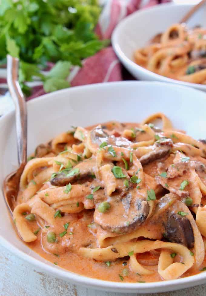 Creamy bosciaola sauce with pasta in bowl with fork