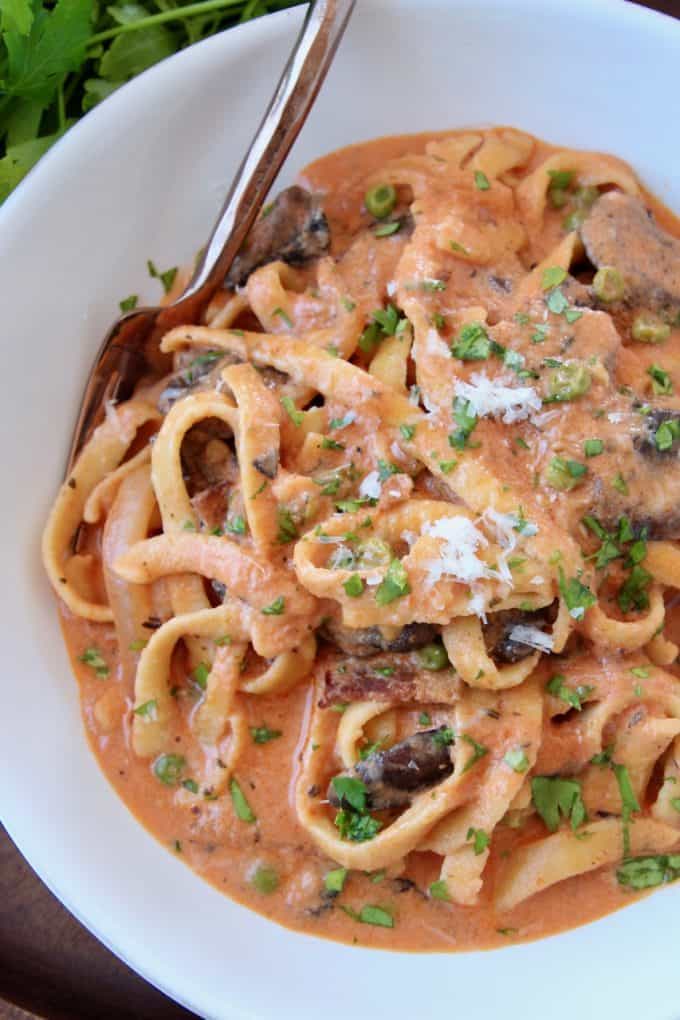Overhead image of pasta in creamy tomato mushroom sauce
