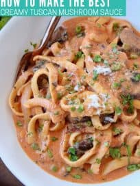 Pasta in creamy tomato mushroom sauce in bowl with fork