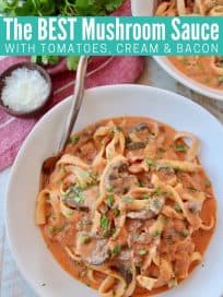 Pasta in creamy tomato mushroom sauce in bowl with fork