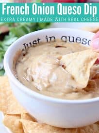 Hand dipping tortilla chip in queso dip