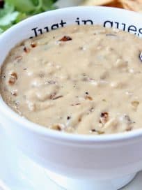 French onion dip queso in bowl with spoon