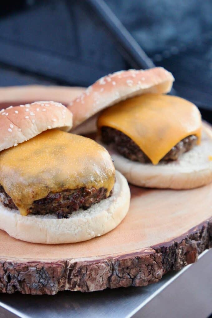 grilled cheeseburgers on wood cutting board