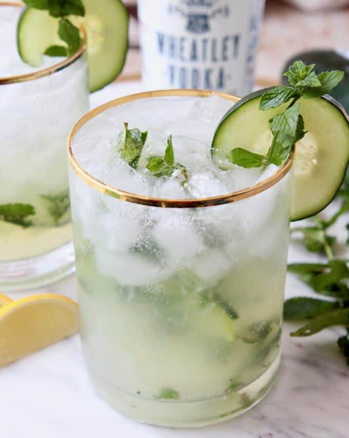 Cocktail in glass with mint spring and slice of cucumber