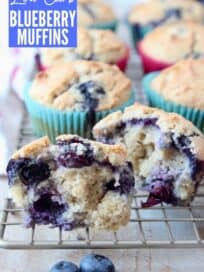 Blueberry muffin split in half on wire baking rack