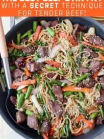 Overhead image of beef stir fry with noodles in skillet with spoon