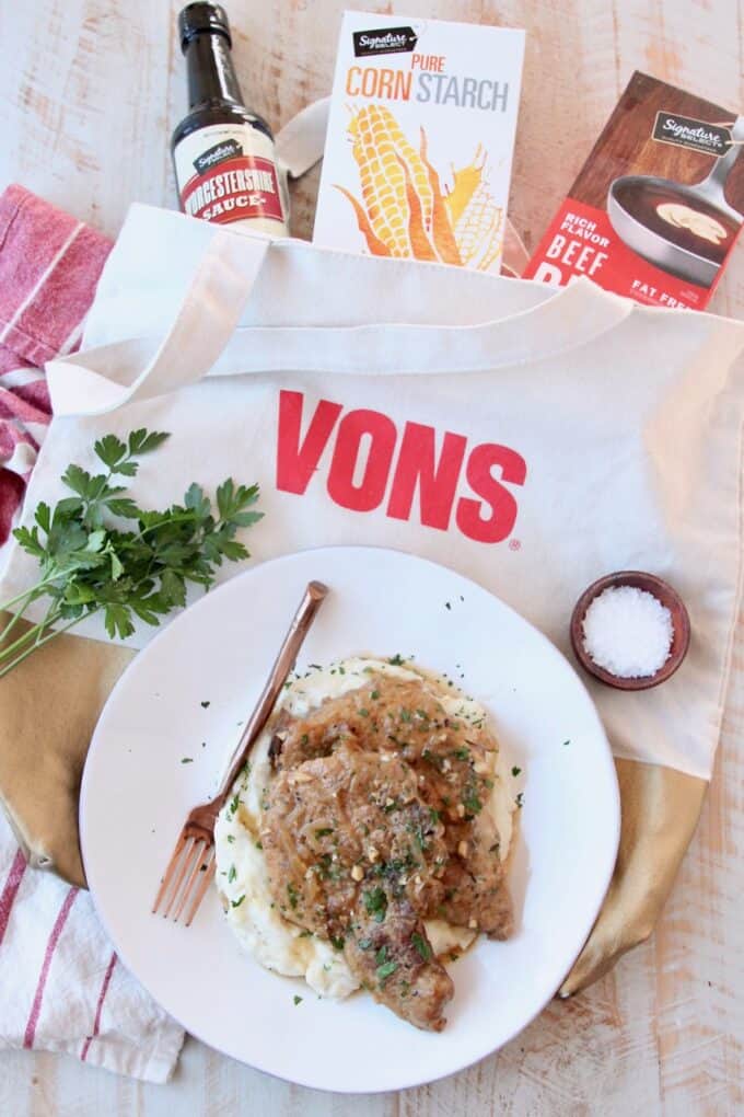 pork chops on plate surrounded by ingredients on shopping bag