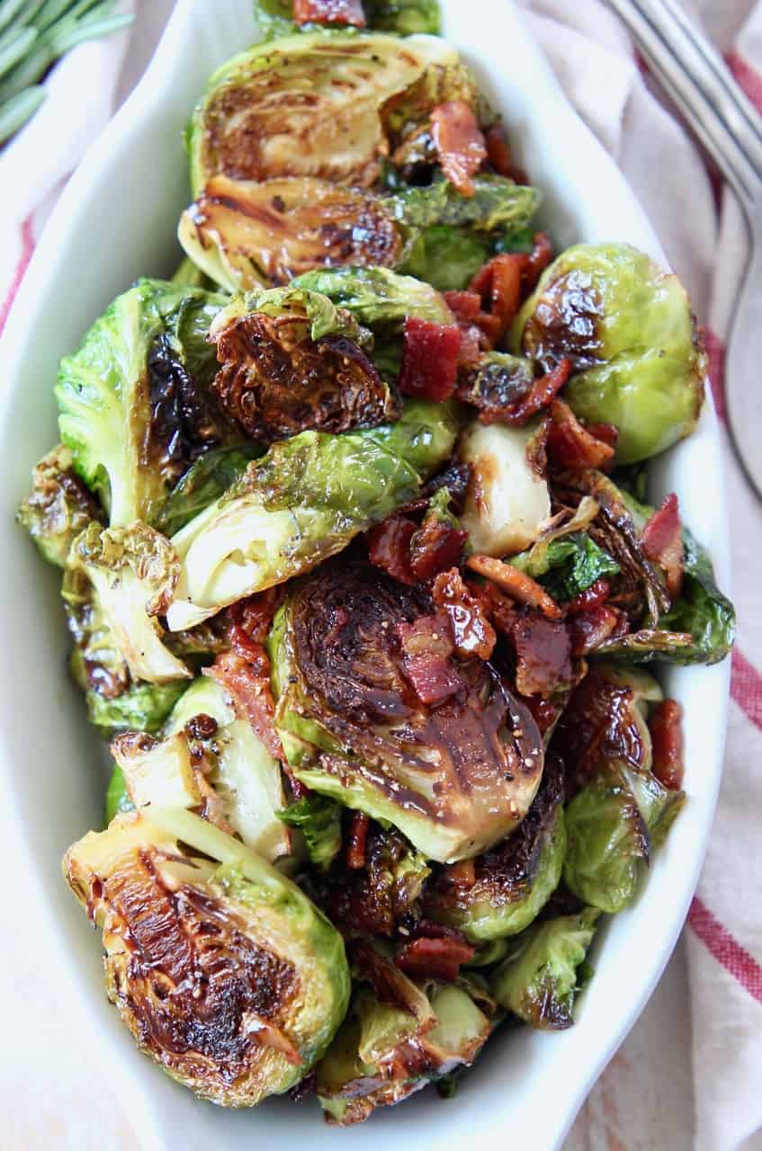 overhead image of cooked brussel sprouts and bacon in serving dish