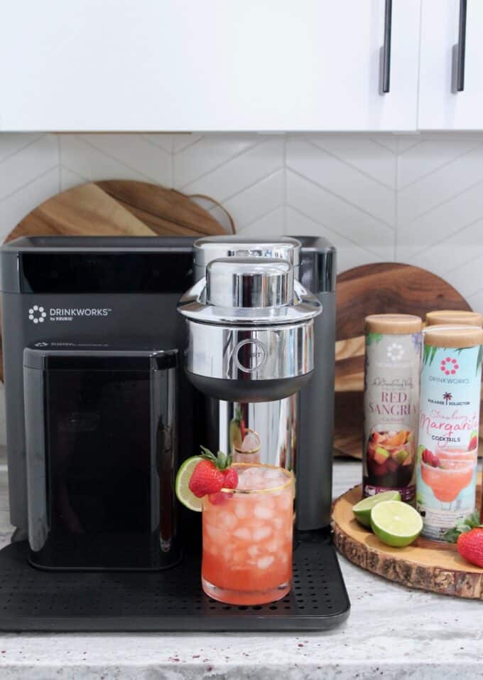 strawberry margarita in glass sitting on Drinkworks home bar appliance