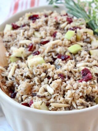 wild rice pilaf in serving dish with wooden serving spoon