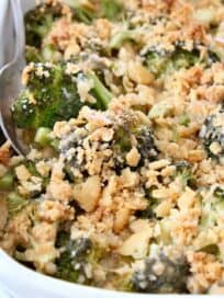 broccoli casserole with ritz cracker topping in dish with serving spoon