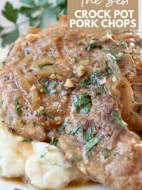 pork chops stacked up on plate on top of mashed potatoes
