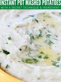 mashed potatoes topped with melted butter and chopped parsley in yellow bowl