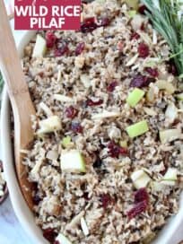 overhead image of wild rice pilaf in serving dish with wooden serving spoon