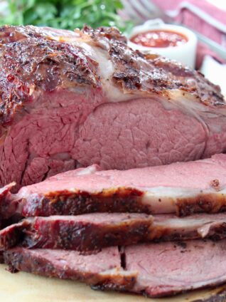 Sliced prime rib on wood cutting board