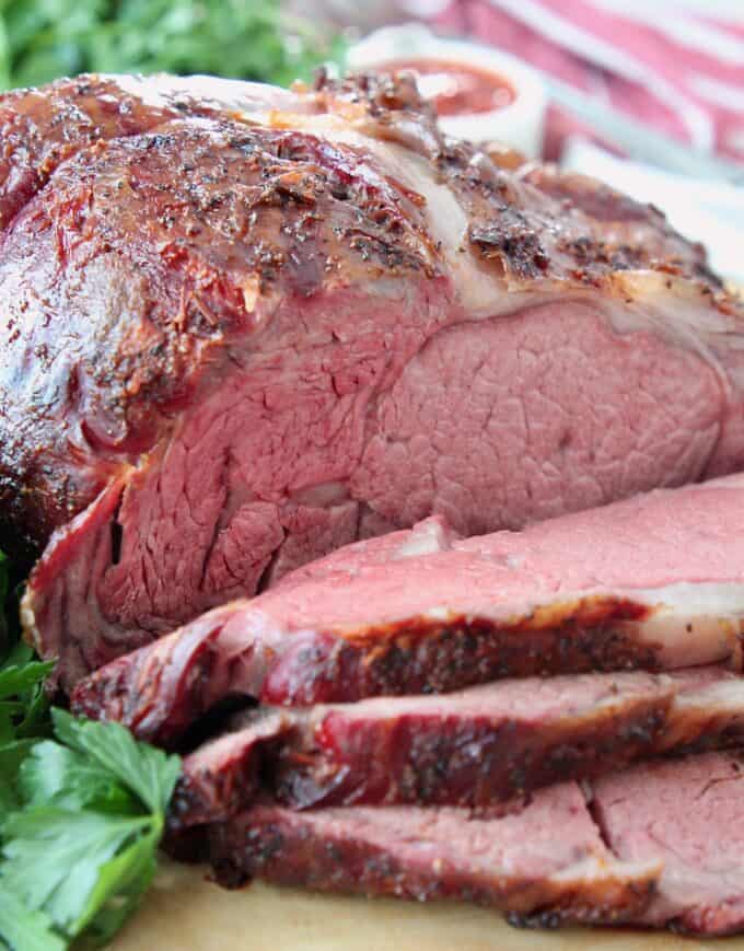 sliced smoked prime rib on wood cutting board