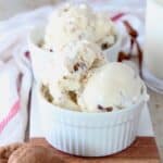 scoops of milk and cookies ice cream in white bowls