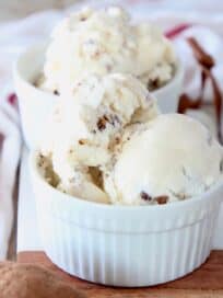 scoops of milk and cookies ice cream in white bowls