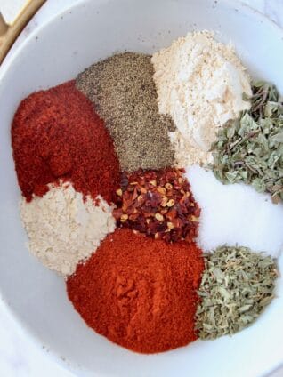 spices and herbs in white bowl