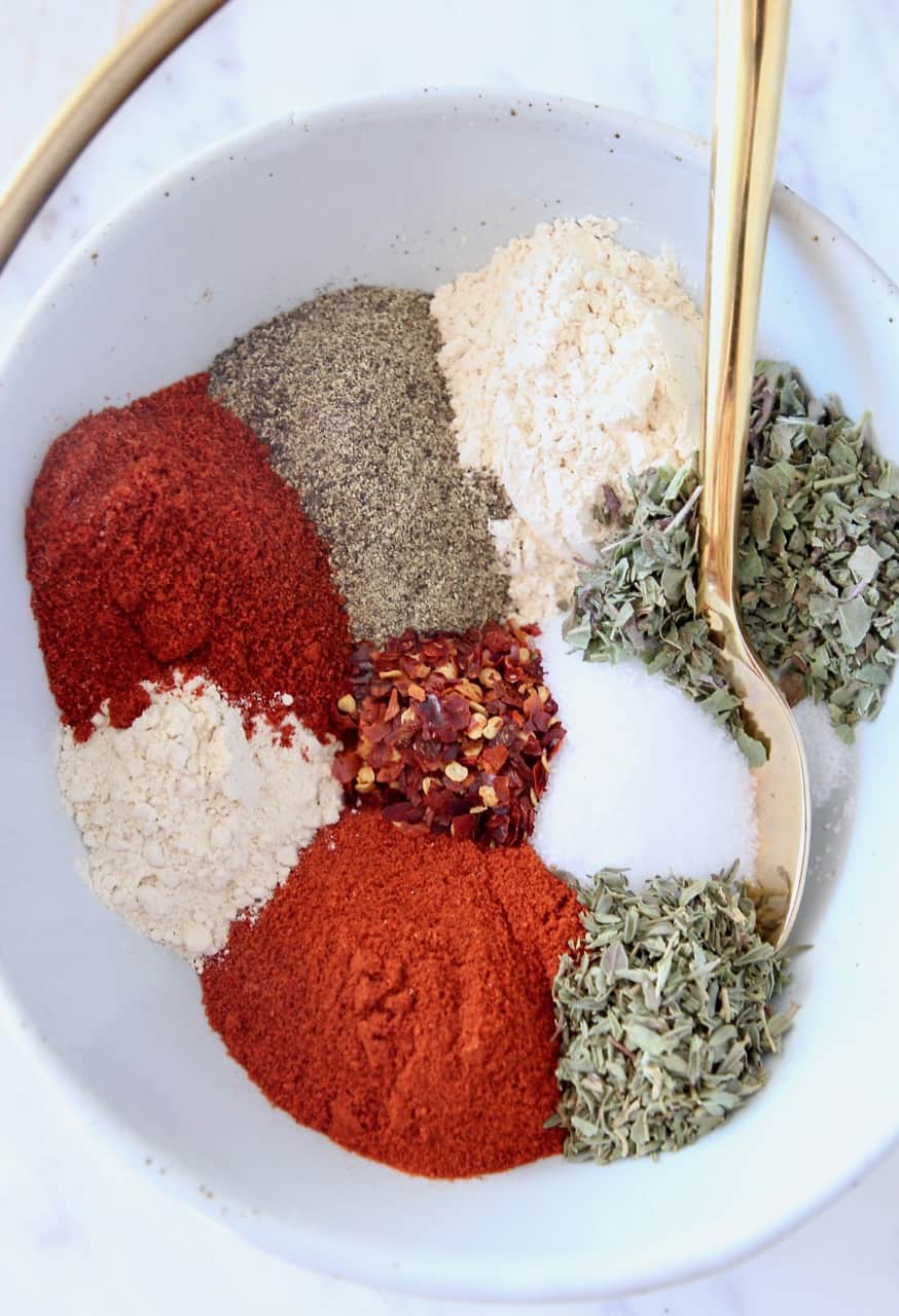 spices in bowl with gold spoon