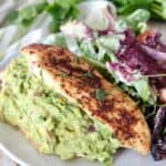 guacamole stuffed chicken on plate with salad